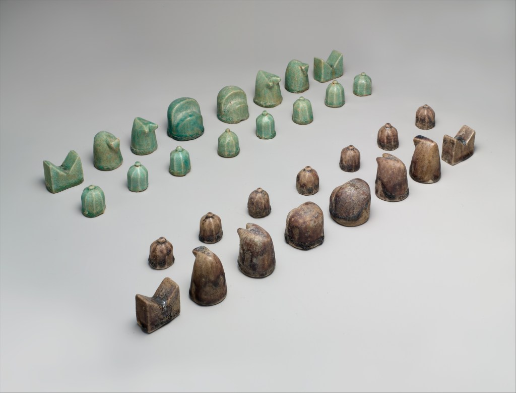 A photograph of a 12th-century chess found in Iran. The green and brown pieces are made out of fritware. The Metropolitan Museum of Art, New York, Pfeiffer Fund, 1971.
